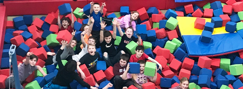 several kids playing in a foam pit during a birthday party at the Keene YMCA