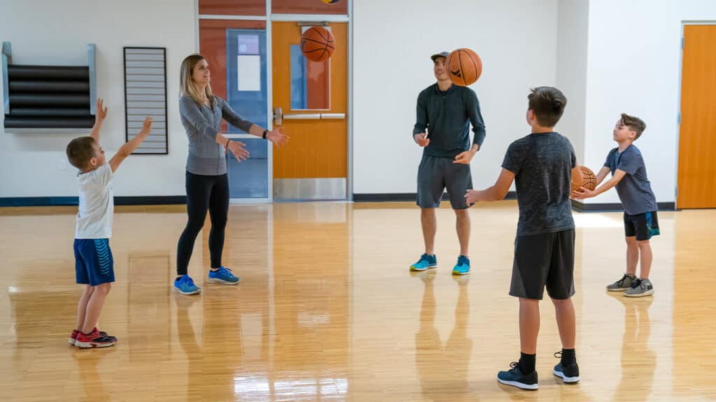 Family playing catch in the gym at the Y