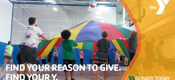 Children playing with a parachute and beach balls